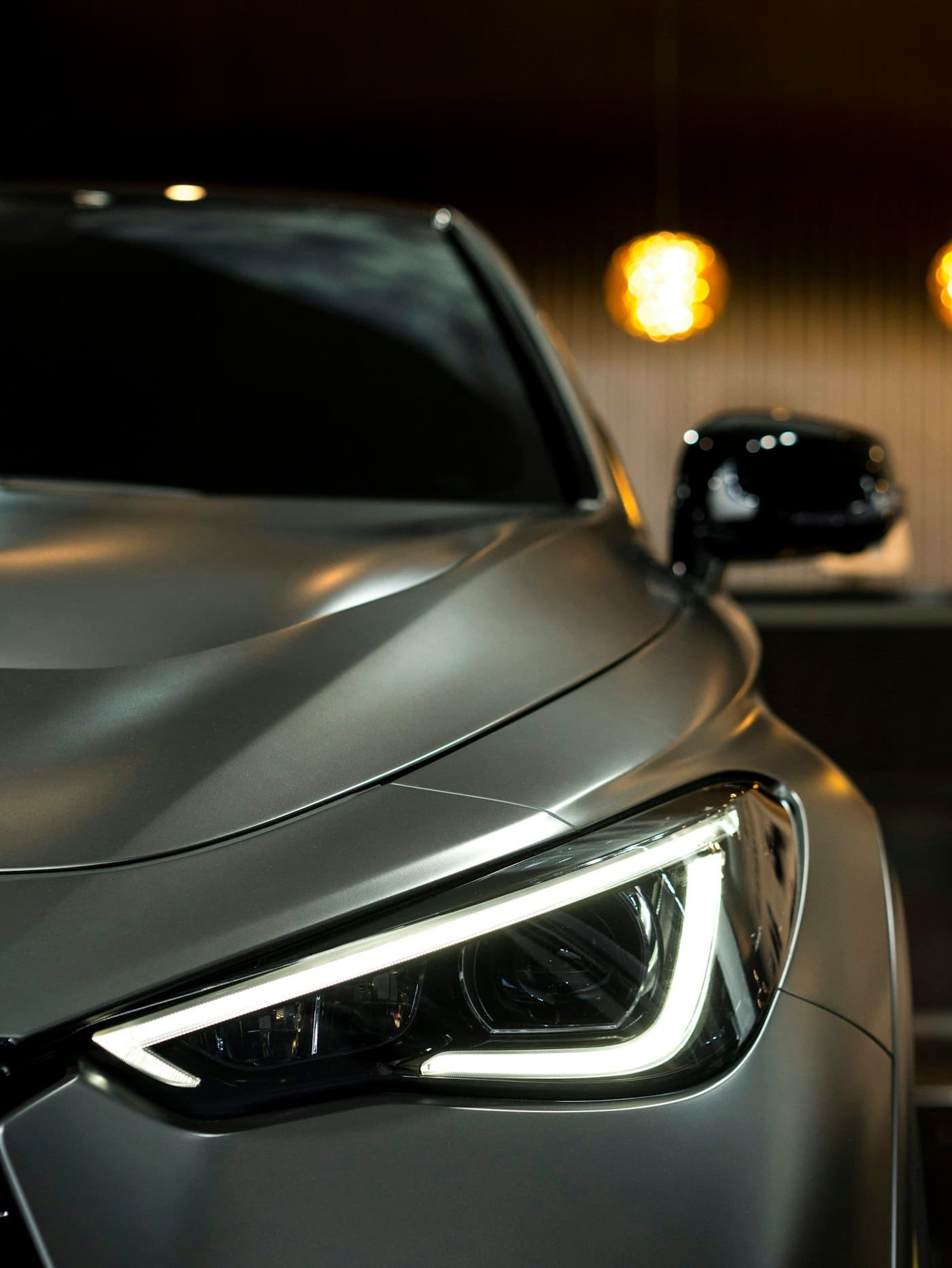 A freshly detailed car under warm showroom light